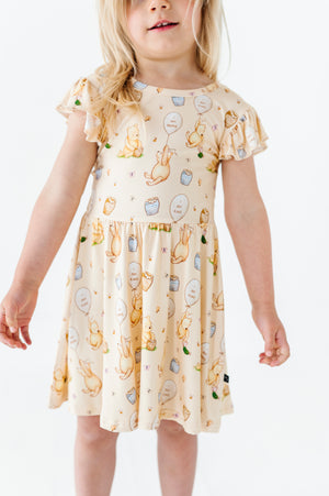 Shop The Sleepy Sloth 100 Acres of Kindness Winnie the Pooh Girls Tiered Flutter Sleeve Twirl Dress with Shorts at Purple Owl Boutique